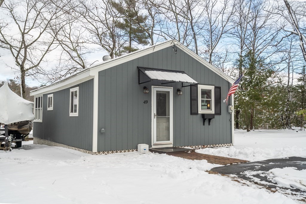 49 Woody Island Road Hopkinton, MA 01748 - Photo 1 of 33 a front view of a house with a yard covered in snow