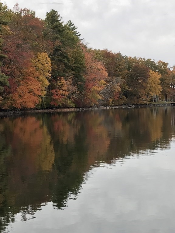 49 Woody Island Road Hopkinton, MA 01748 - Photo 25 of 33 a view of a lake with a mountain in the background