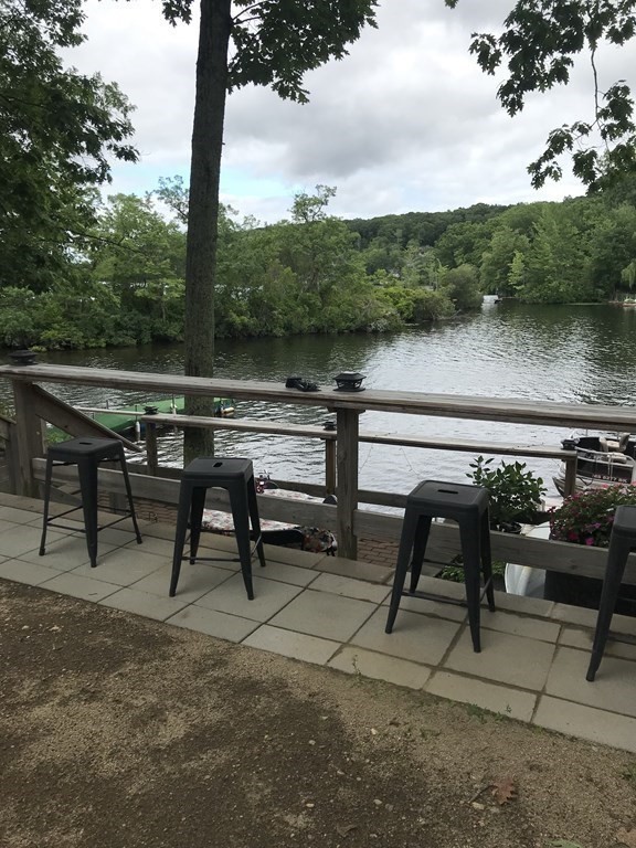 49 Woody Island Road Hopkinton, MA 01748 - Photo 30 of 33 a view of a lake with outdoor seating