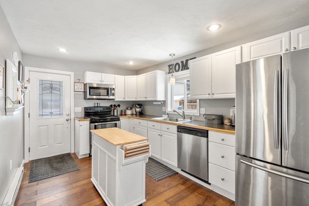 49 Woody Island Road Hopkinton, MA 01748 - Photo 5 of 33 a kitchen with stainless steel appliances granite countertop a refrigerator stove microwave and sink