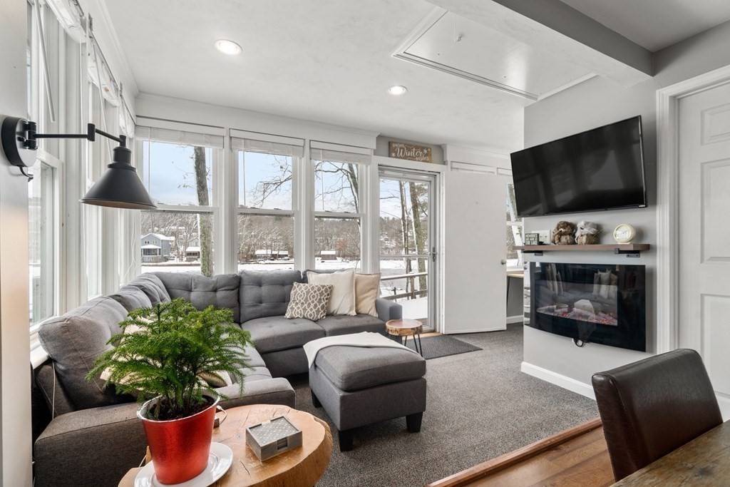 49 Woody Island Road Hopkinton, MA 01748 - Photo 9 of 33 a living room with furniture fireplace and flat screen tv