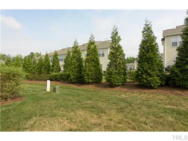7660 Winners Edge Street Raleigh, NC 27617 - Photo 10 of 12 Patio and storage views. End unit has more privacy and a side yard compared to other plans. Leeland cypress buffer will continue to grow up and out- provides great privacy block from other homes.