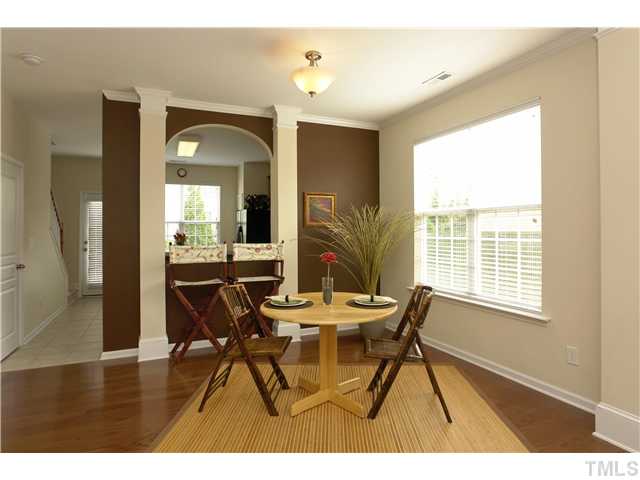 7660 Winners Edge Street Raleigh, NC 27617 - Photo 12 of 12 Separate dining option w/ double side window, gorgeous hardwoods, craftsman archway passthrough to kitchen, heavy square column accents, wood blinds, three panel doors throughout, brushed nickel lighting package, crown molding. Very open floor plan!