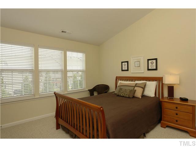 7660 Winners Edge Street Raleigh, NC 27617 - Photo 6 of 12 Large master includes triple window w/ wood blinds, TWO closets (one walk in), vaulted ceilings, neutral paint and BERBER carpet upper floor. This room is almost 170 sq ft and seller has a lot of furniture (not shown)- can accomodate a large bdr set.