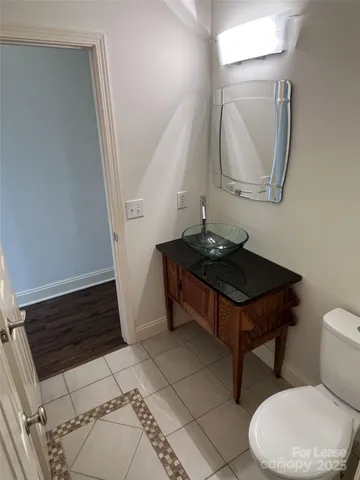 a bathroom with a toilet a sink and a mirror