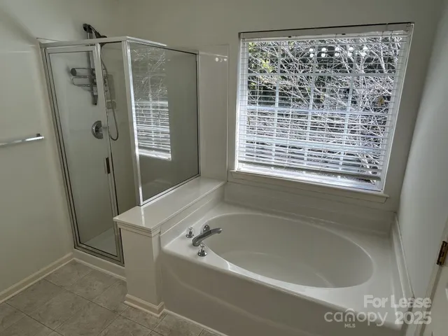 a bathroom with a bathtub and a shower