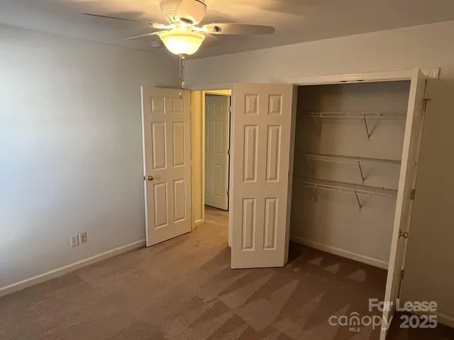 an empty room with windows and cabinet