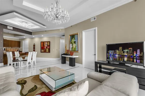 a living room with furniture and a chandelier