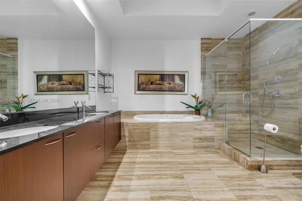 a bathroom with a tub and a shower