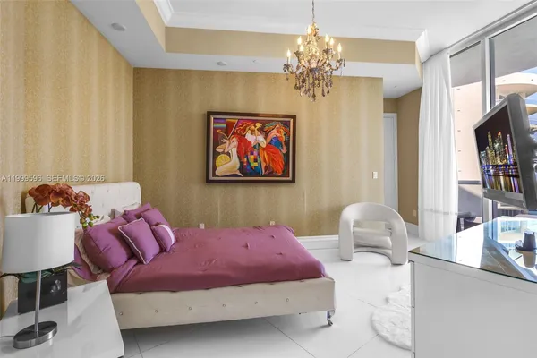 a bedroom with furniture and a chandelier