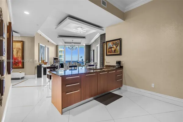 a large kitchen with stainless steel appliances granite countertop a large counter top and a stove