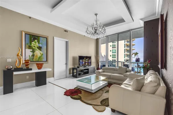 a living room with furniture or chandelier and a fireplace