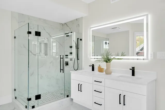 a bathroom with a shower sink and mirror