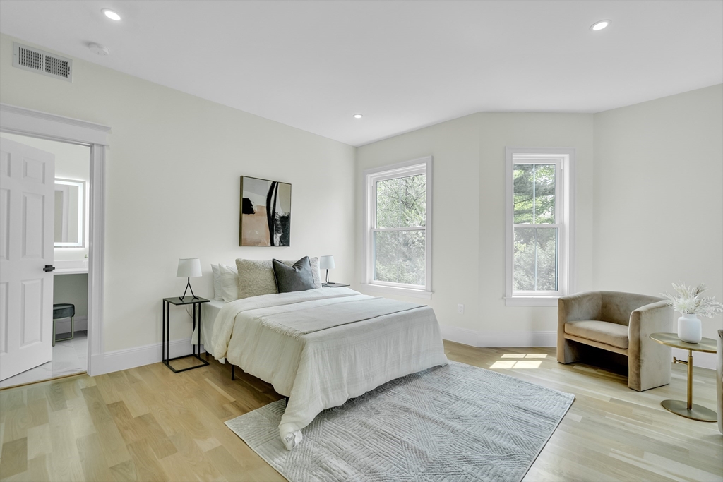 686 Centre Street Newton, MA 02458 - Photo 12 of 26 a bedroom with a bed and a chair