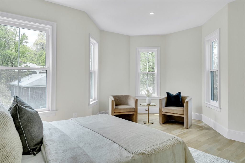 686 Centre Street Newton, MA 02458 - Photo 13 of 26 a bedroom with a bed a large window and couch