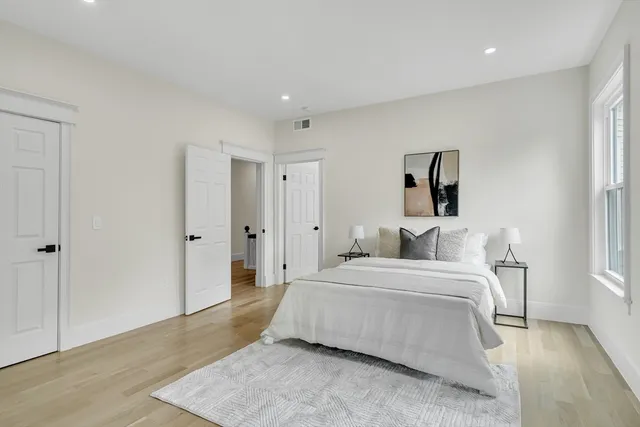 a bedroom with a bed and a couch