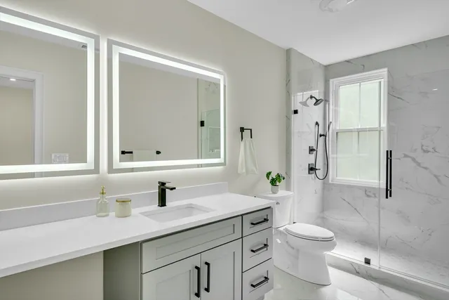 a bathroom with a sink toilet and shower