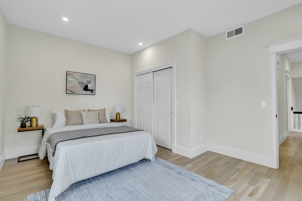 686 Centre Street Newton, MA 02458 - Photo 17 of 26 a bedroom with a bed and wooden floor