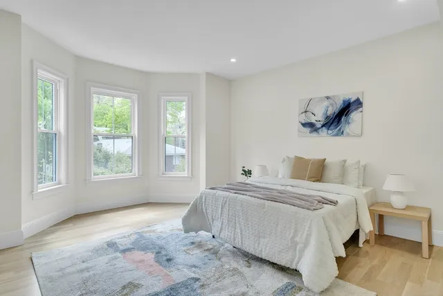 a bedroom with a large bed and a window