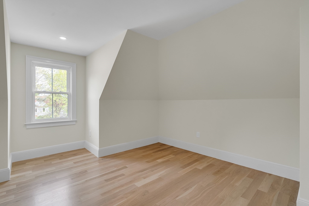 686 Centre Street Newton, MA 02458 - Photo 21 of 26 an empty room with wooden floor and windows