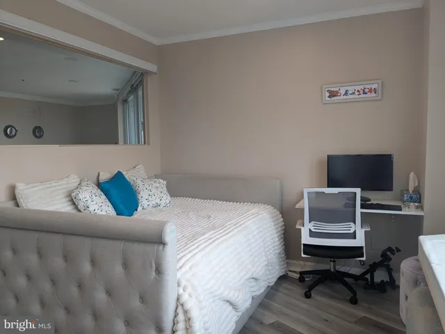 a bedroom with a bed and a television