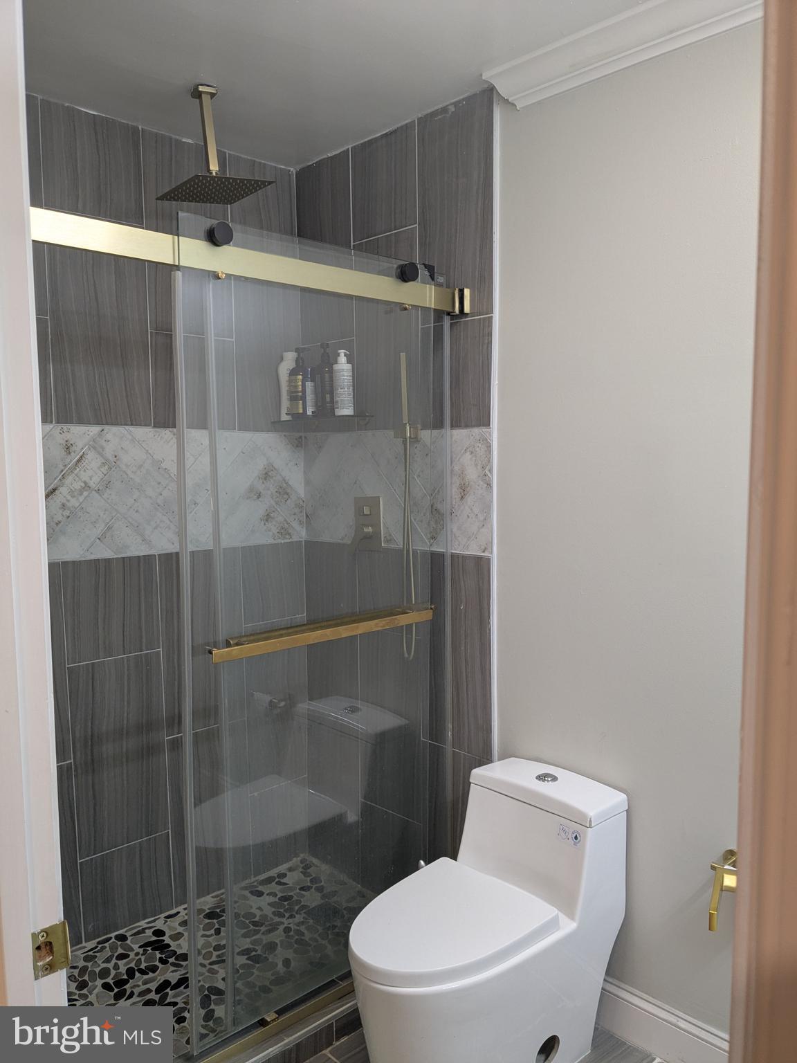 100 Harborview Drive, Unit 211 Baltimore, MD 21230 - Photo 18 of 25 a bathroom with a toilet and a shower