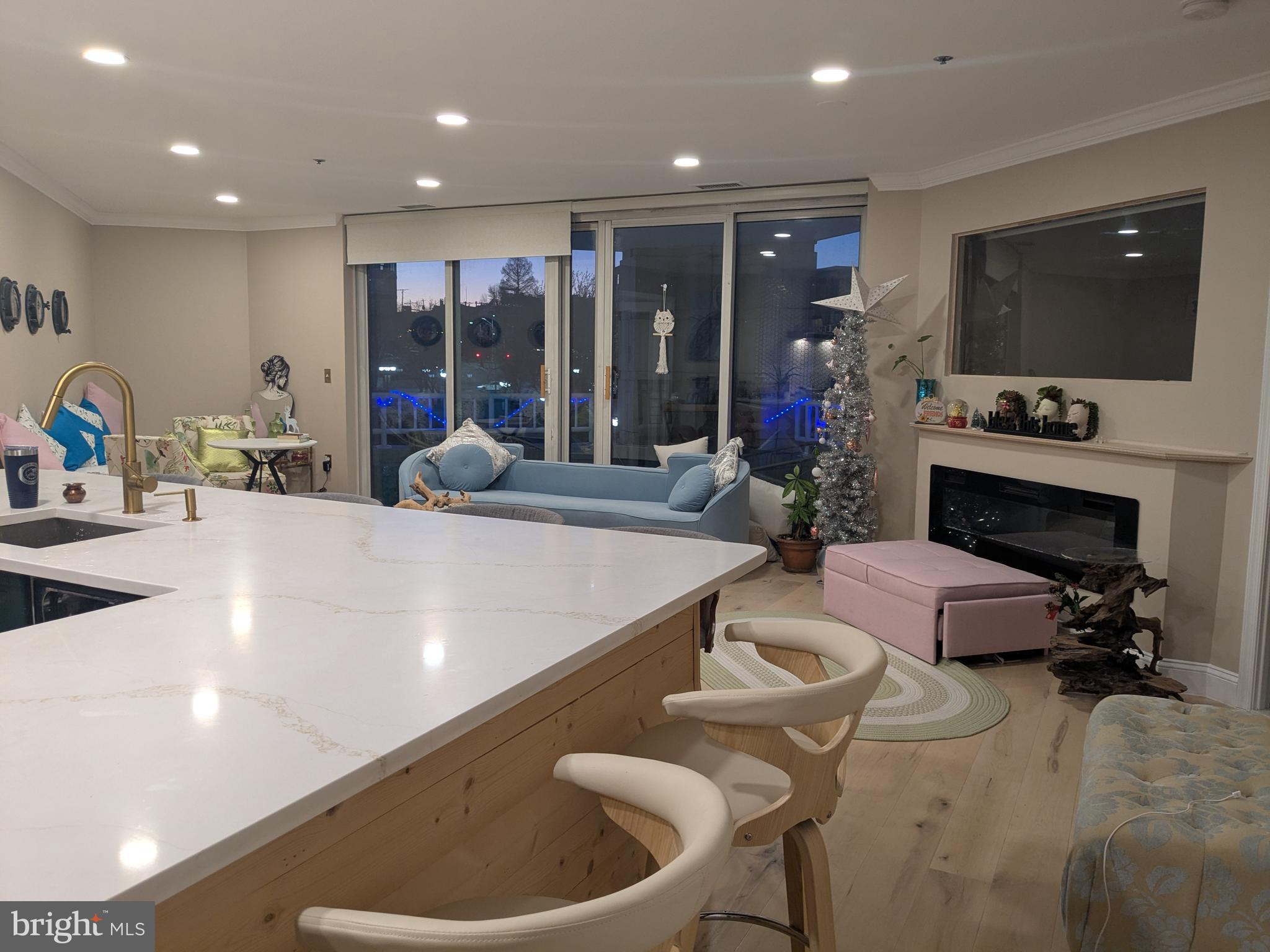 100 Harborview Drive, Unit 211 Baltimore, MD 21230 - Photo 9 of 25 a living room with fireplace furniture and a flat screen tv