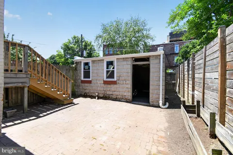 a view of a house with brick walls