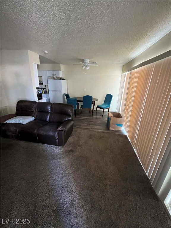 1388 East Desert Inn Road, Unit 2(ROOM A) Las Vegas, NV 89169 - Photo 3 of 13 Living area with ceiling fan, a textured ceiling,