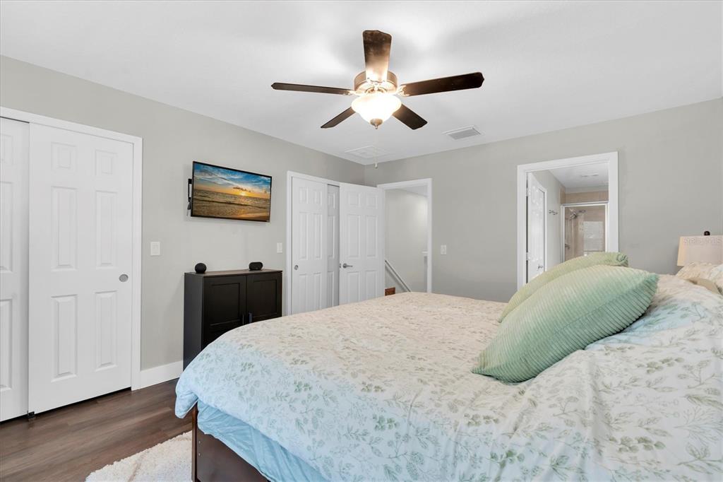5233 Sylvester Loop Tampa, FL 33610 - Photo 14 of 36 a bedroom with a bed and a chandelier