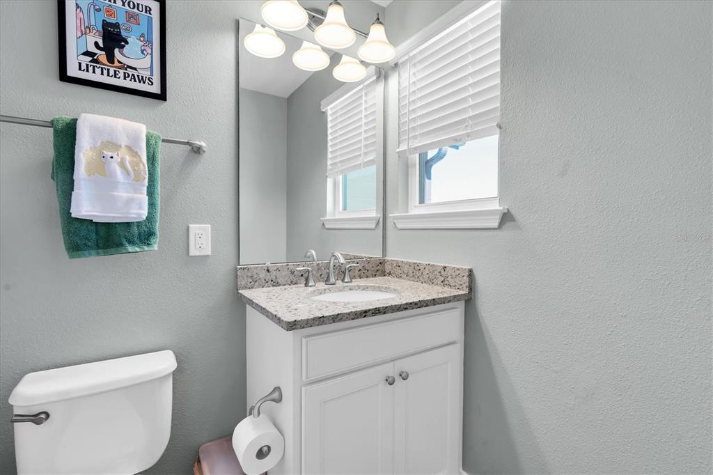 5233 Sylvester Loop Tampa, FL 33610 - Photo 18 of 36 a bathroom with a toilet a sink and a mirror