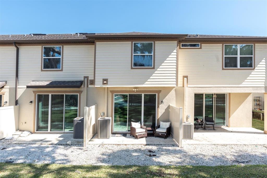 5233 Sylvester Loop Tampa, FL 33610 - Photo 26 of 36 a front view of a house with a yard outdoor seating and barbeque oven