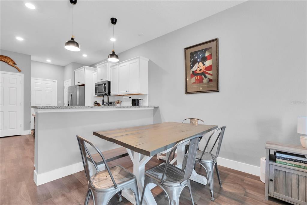 5233 Sylvester Loop Tampa, FL 33610 - Photo 8 of 36 a view of a dining room with furniture and wooden floor