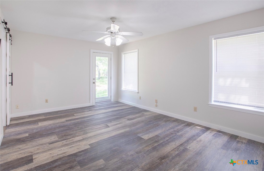 188 Cavalry Road Victoria, TX 77905 - Photo 8 of 30 a view of an empty room with a window and wooden floor