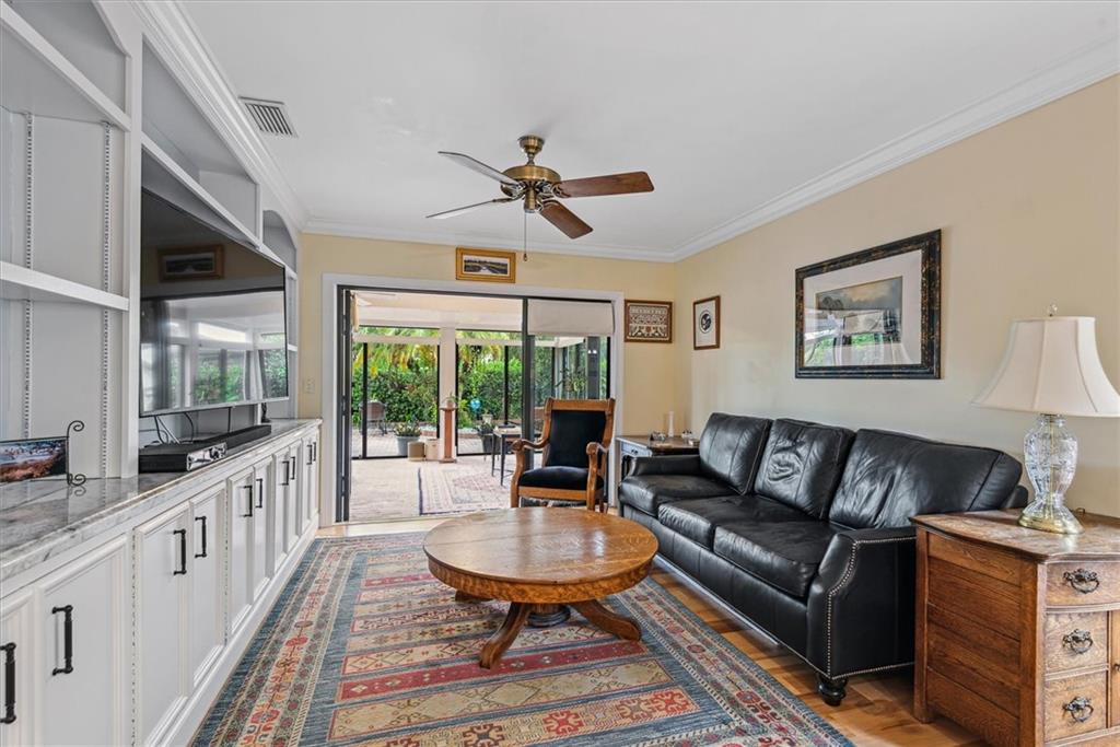 8680 Eagle Run Drive Boca Raton, FL 33434 - Photo 11 of 34 a living room with furniture ceiling fan and a rug
