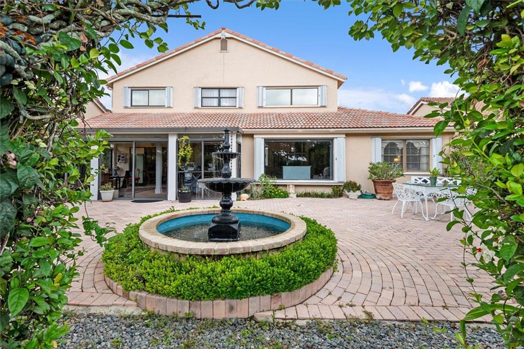 8680 Eagle Run Drive Boca Raton, FL 33434 - Photo 22 of 34 a front view of a house with porch and chairs