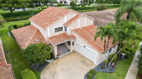 a aerial view of a house with a yard and potted plants