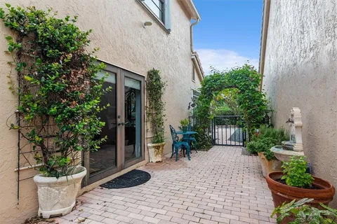 a view of a backyard with potted plants and a fountain