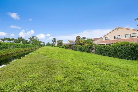 a view of a big yard with plants and a garden