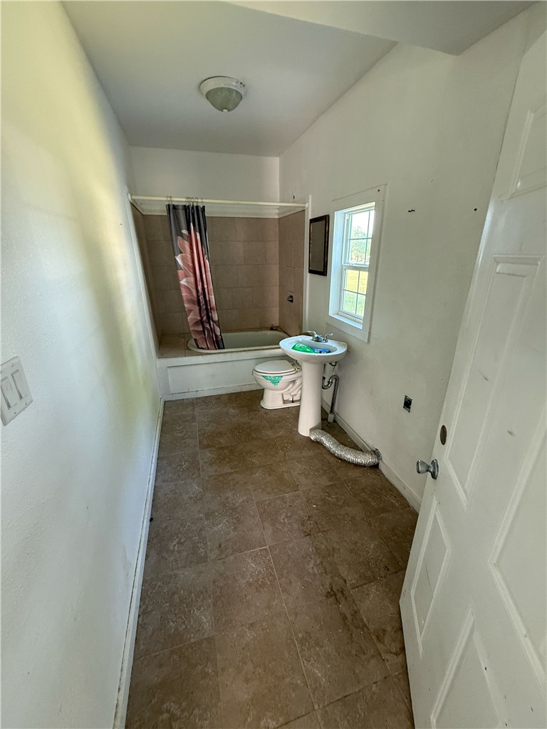 507 Logan Street Calvert, TX 77837 - Photo 8 of 19 a view of empty room with wooden floor and fan