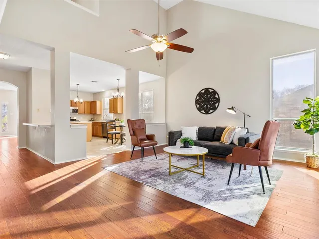 a living room with furniture and view of kitchen
