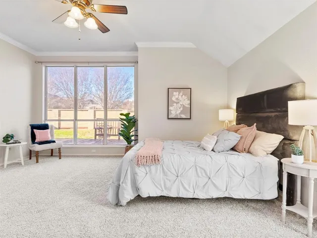 a bedroom with a bed and large window