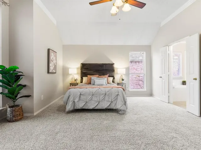 a bedroom with a bed and a potted plant