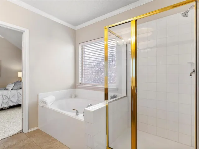a bathroom with a bathtub and shower