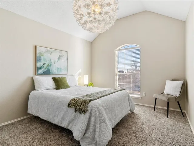 a bedroom with a bed chair and window