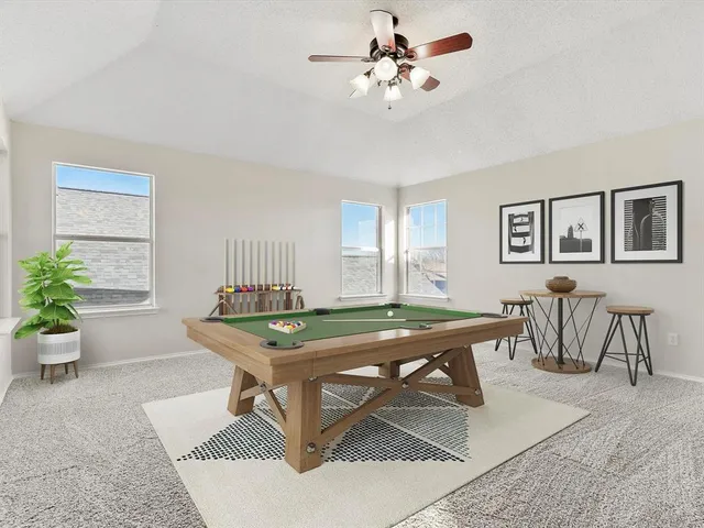 a room with furniture pool table and windows