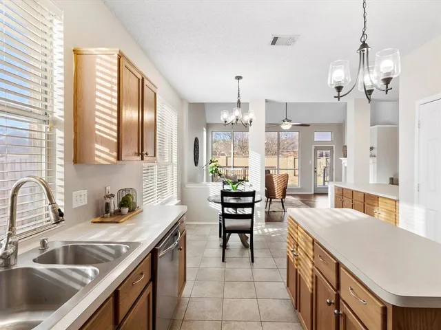 a kitchen with a sink stove and cabinets