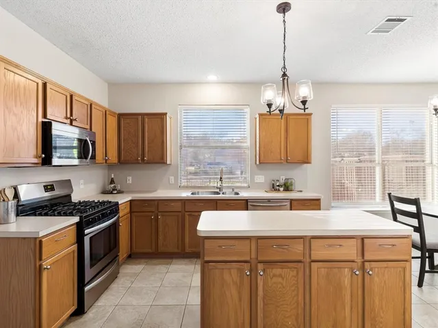 a kitchen with a sink stove and microwave