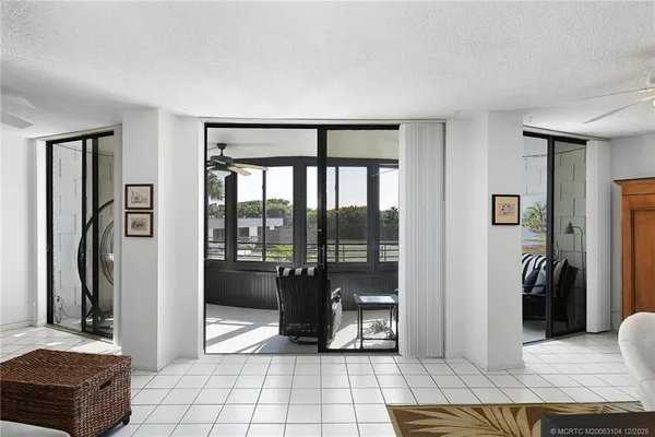 a living room with furniture and a floor to ceiling window