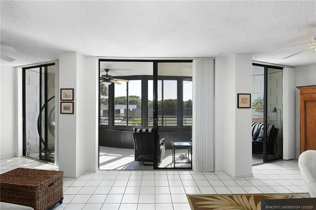 a living room with furniture and a floor to ceiling window